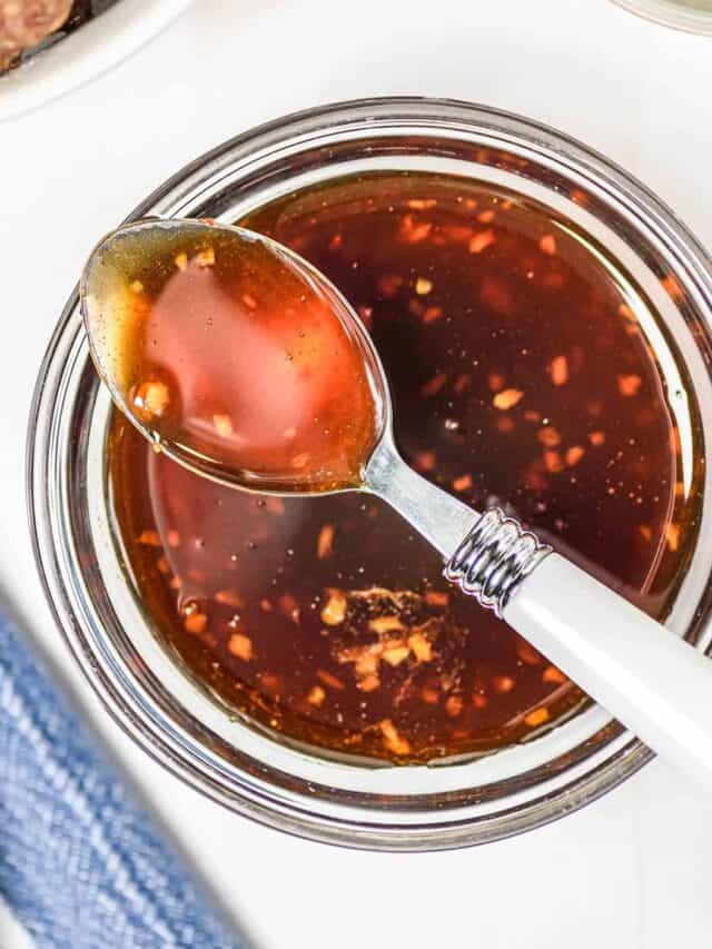 Honey sriracha sauce in a bowl with a spoon