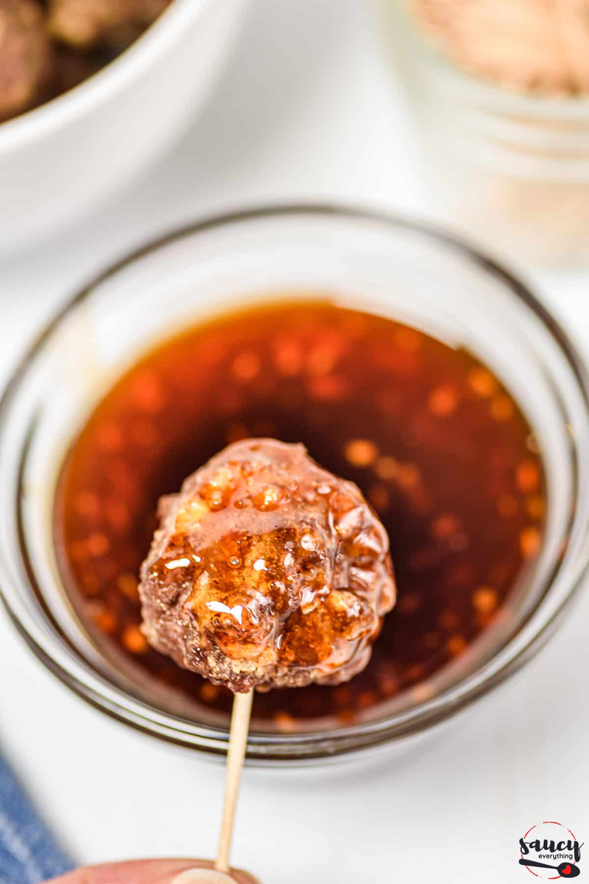 Honey sriracha sauce with a meatball on a toothpick
