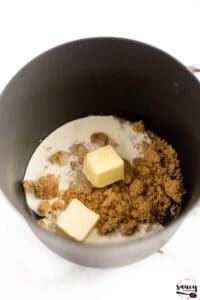 Ingredients to make butterscotch sauce in a pot