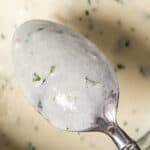 garlic cream sauce in a bowl with a spoon
