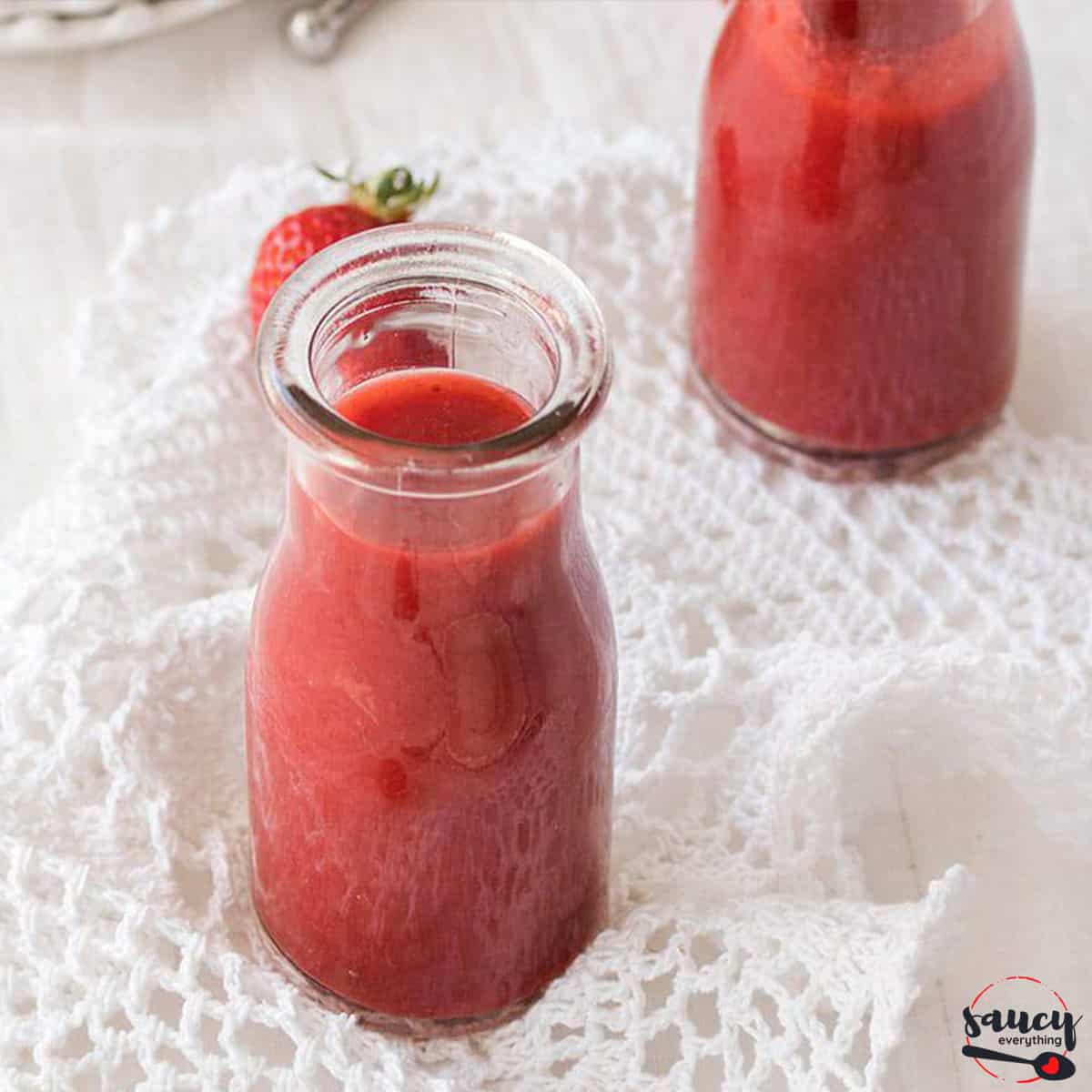 Strawberry sauce in two glass containers