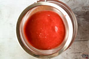 Straining strawberry sauce