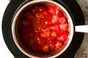 Strawberries in a sauce pan cooking down
