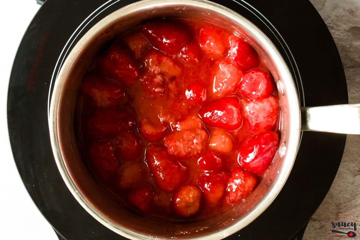 Strawberries in a sauce pan cooking down