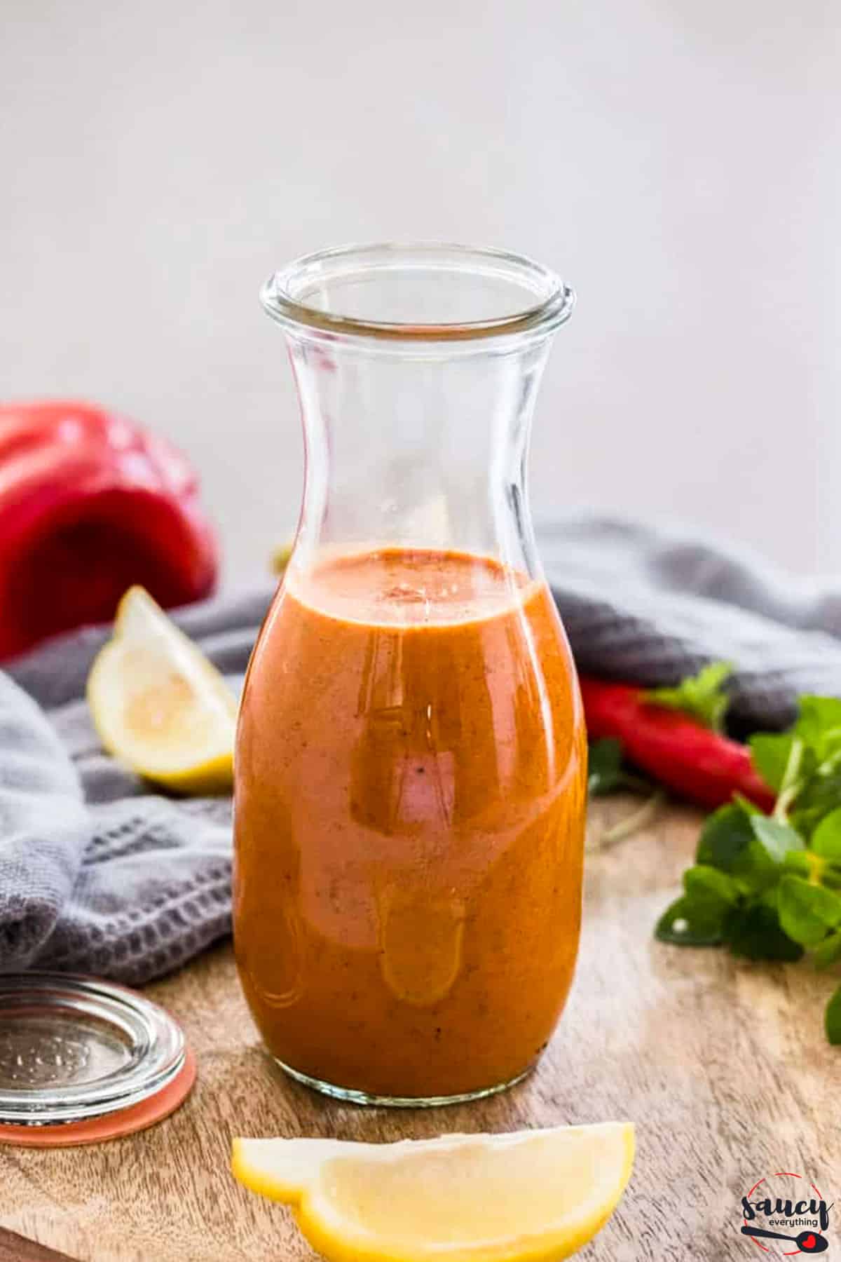 Peri peri sauce in a bottle near lemon slices