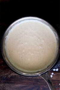 completed alfredo sauce bubbling in skillet