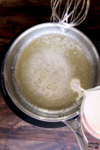 pouring heavy cream into melted butter
