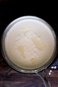 american cheese slices in a skillet of heavy cream