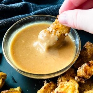 Dipping a chicken nugget in chick-fil-a sauce