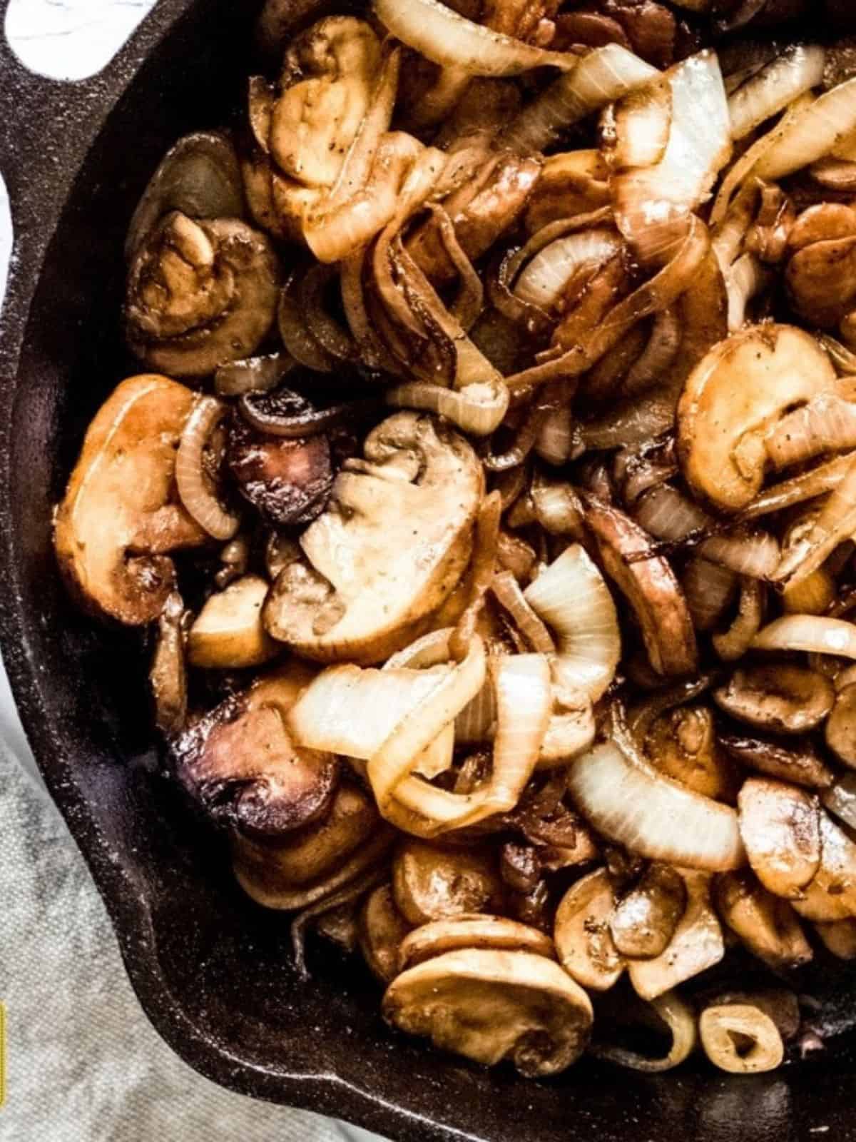 Mushrooms and onions in a skillet cooked down.