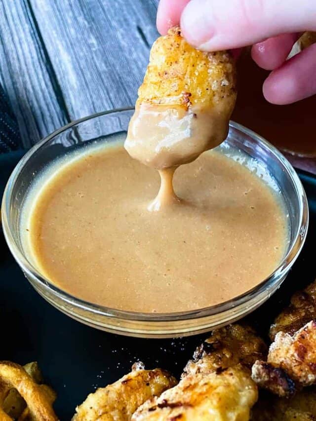 Dipping a chicken nugget in chick-fil-a sauce