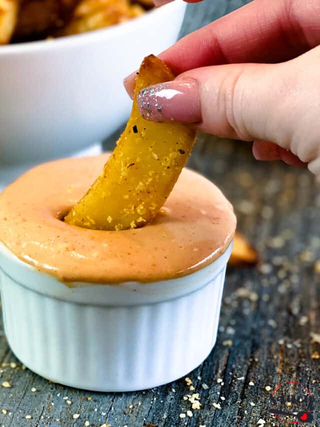Dipping a french fry in fry sauce