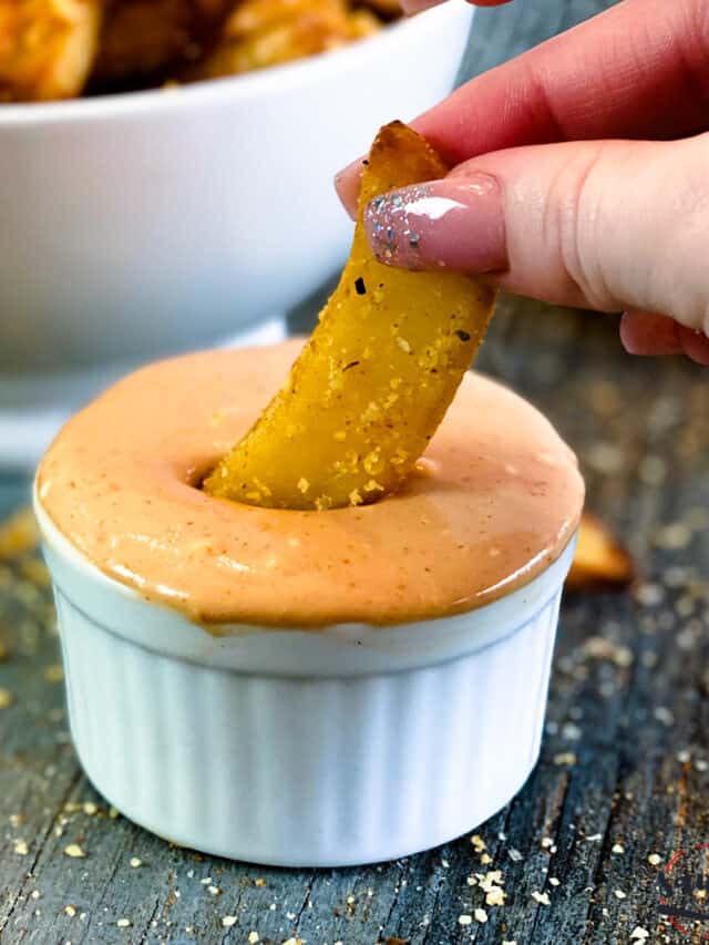 Dipping a french fry in fry sauce