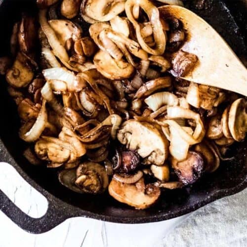 Mushrooms and onions sauteed in a cast iron pan
