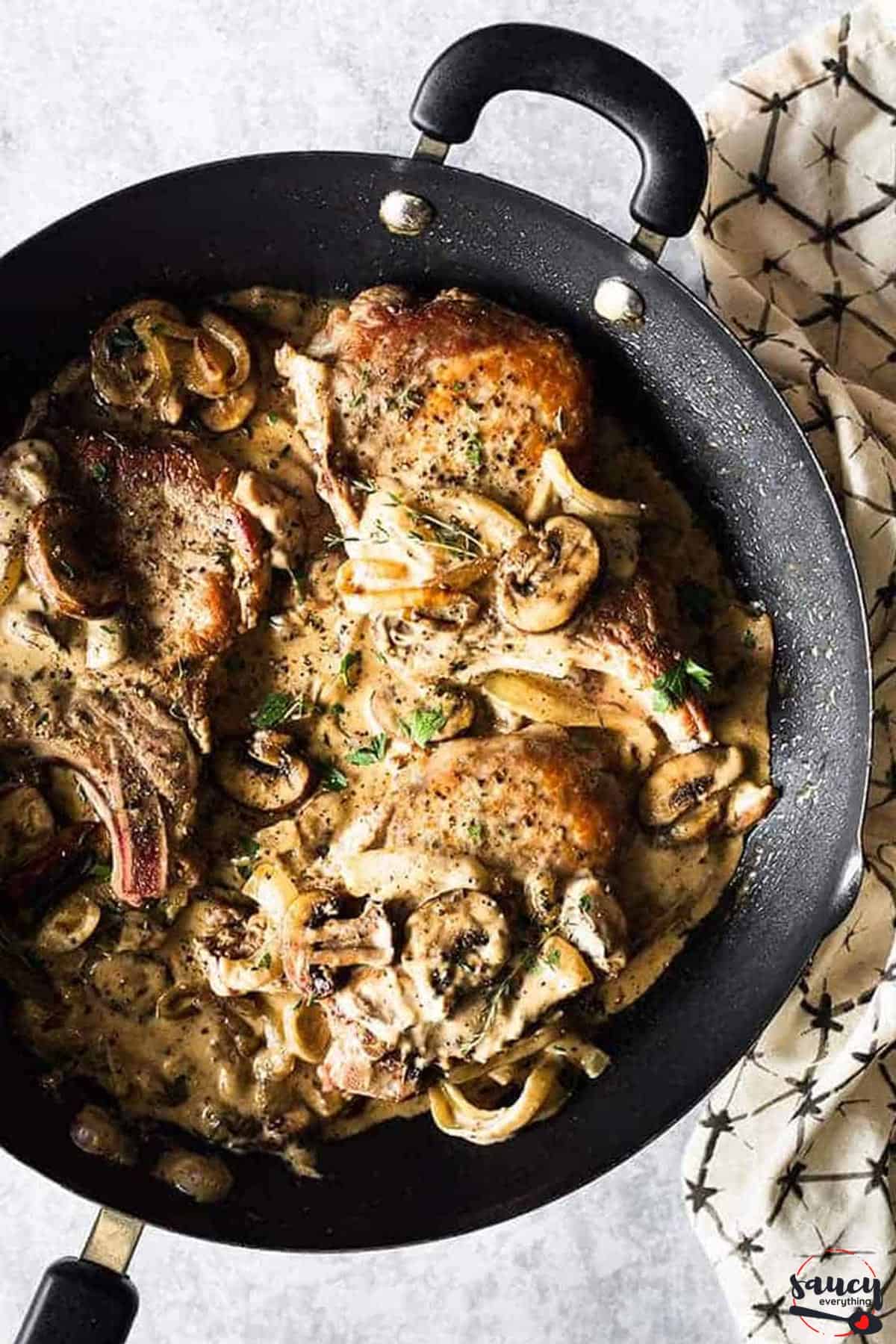 Mushrooms and onions served with pork chops in a cream sauce