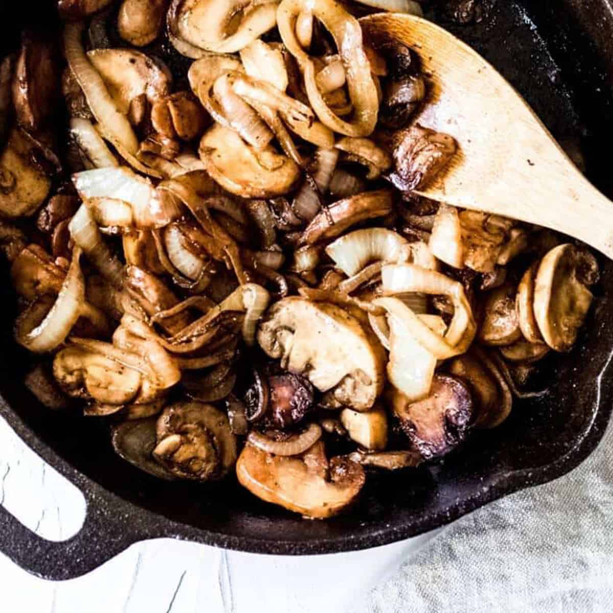 Mushrooms and onions sauteed in a cast iron pan