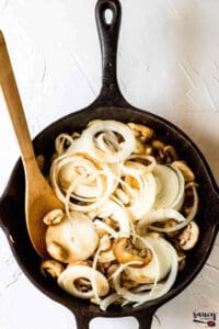 Mushrooms and onions in a cast iron pan