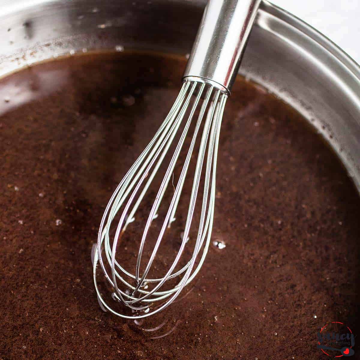 Complete au jus in pan with whisk close up