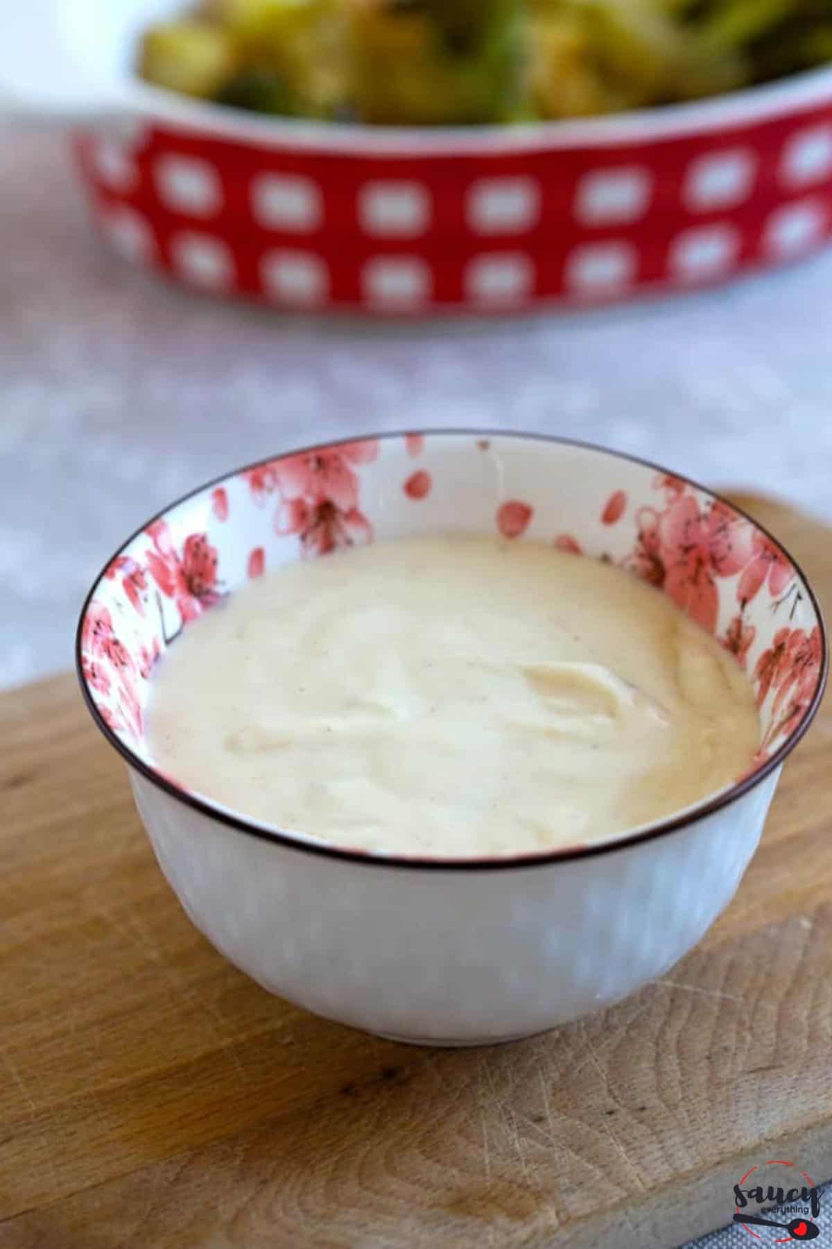 Cheese sauce in a red and white bowl