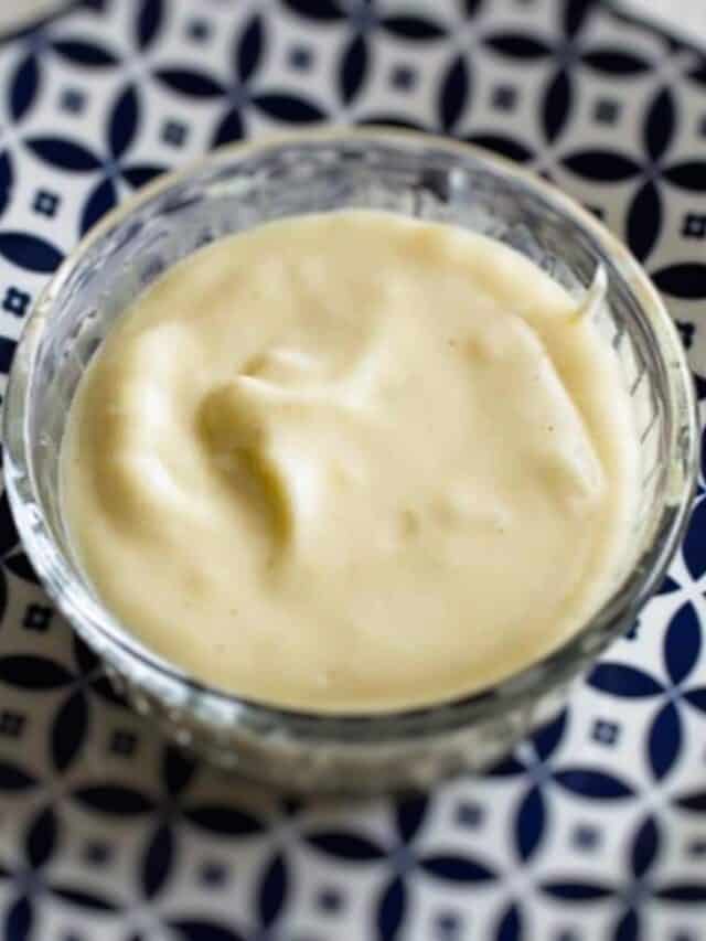 White cheese sauce in a glass bowl.
