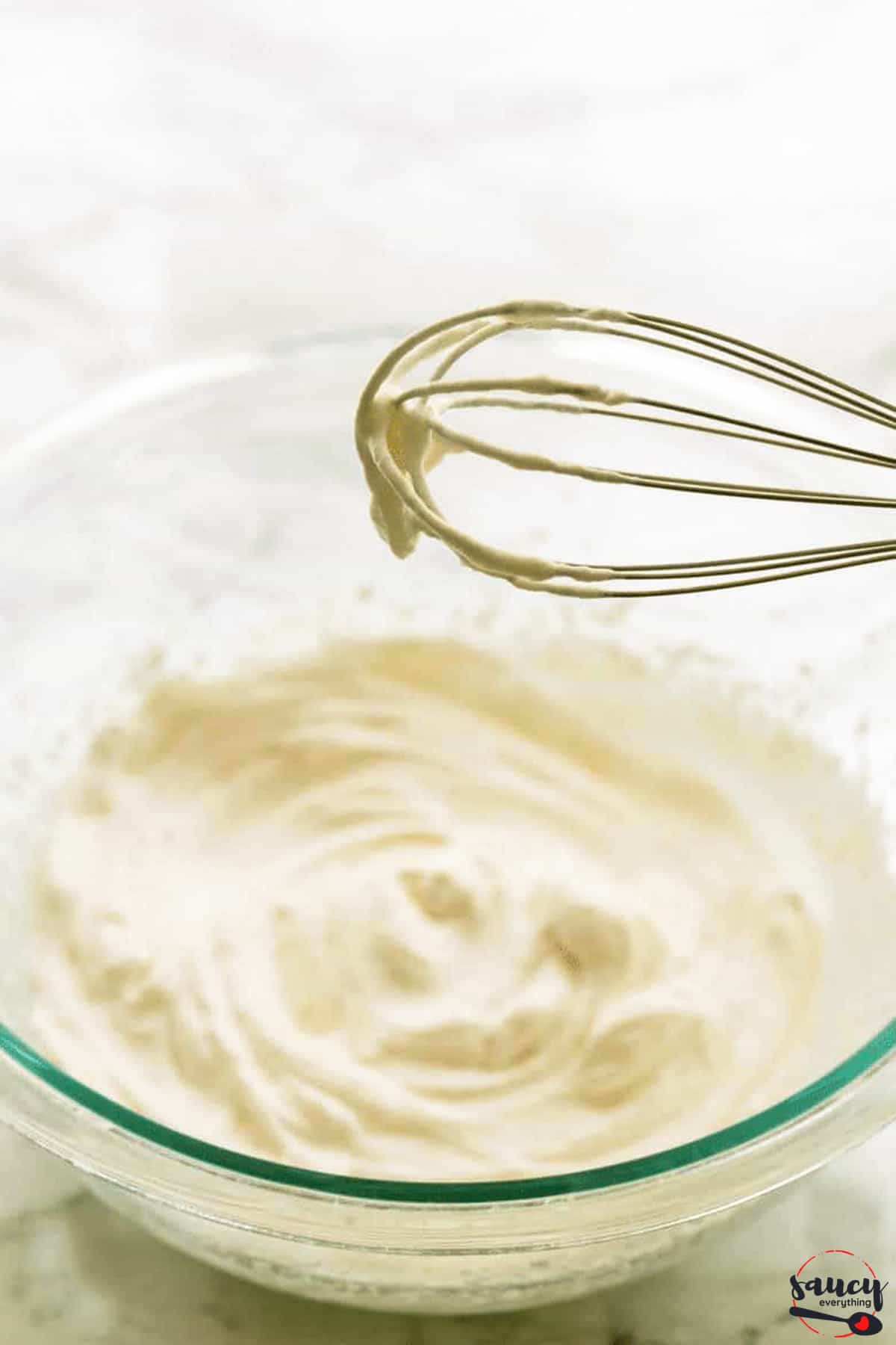 Whipped cream in a bowl after mixing