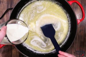 Pouring cream into skillet with lemon and butter