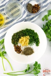 Chimichurri sauce ingredients in a white bowl