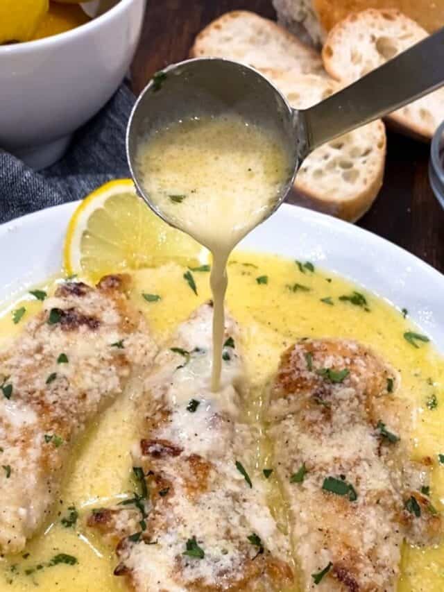 lemon butter being poured over chicken.