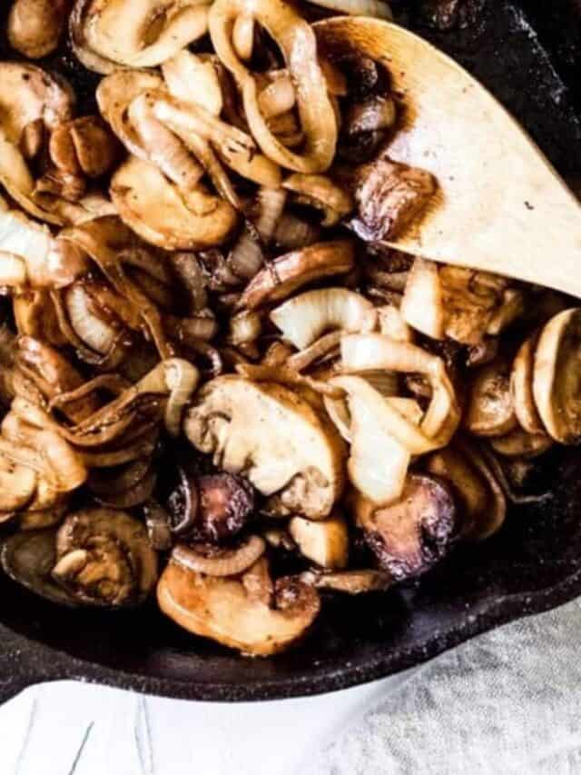Mushrooms and onions cooked down in a skillet.