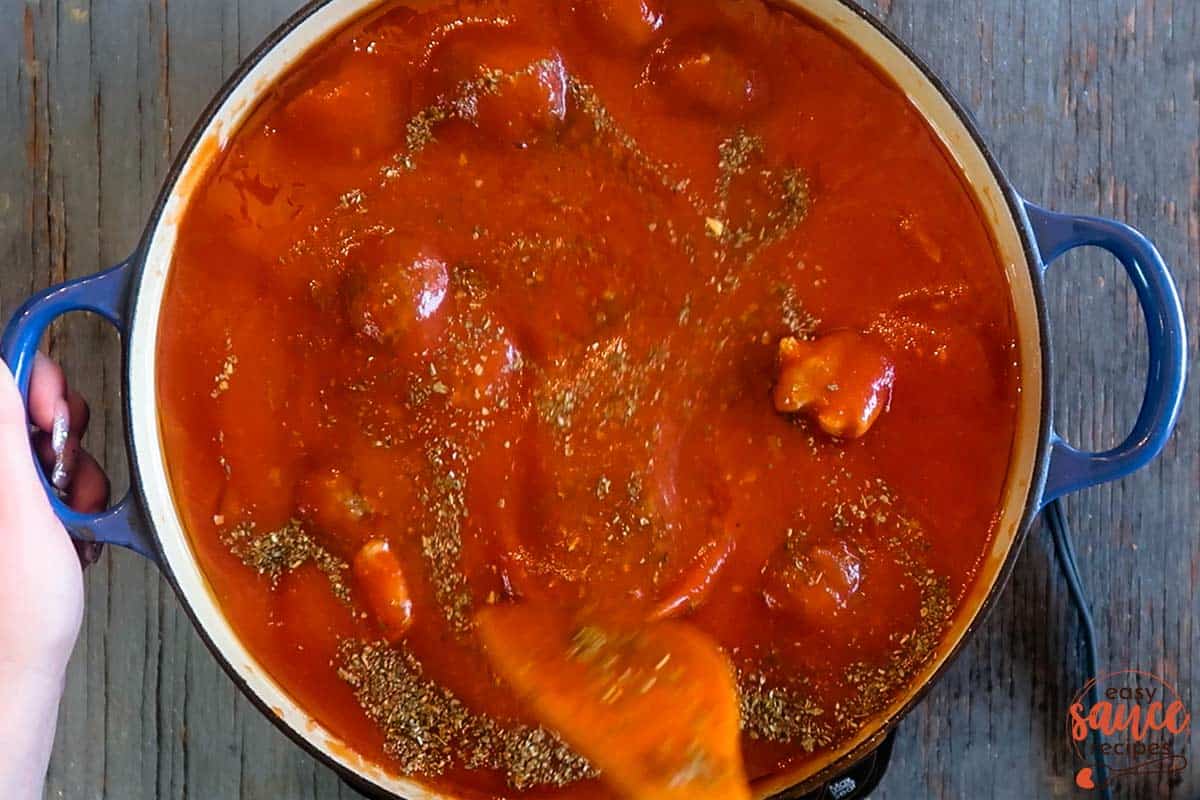 Mixing meatball sauce in a pot