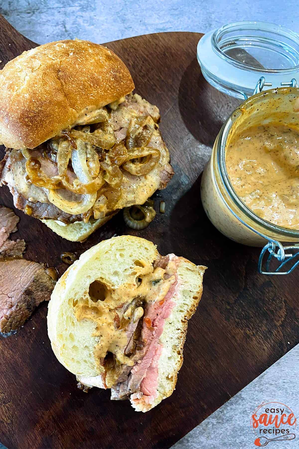 Remoulade sauce on two hot roast beef sandwiches