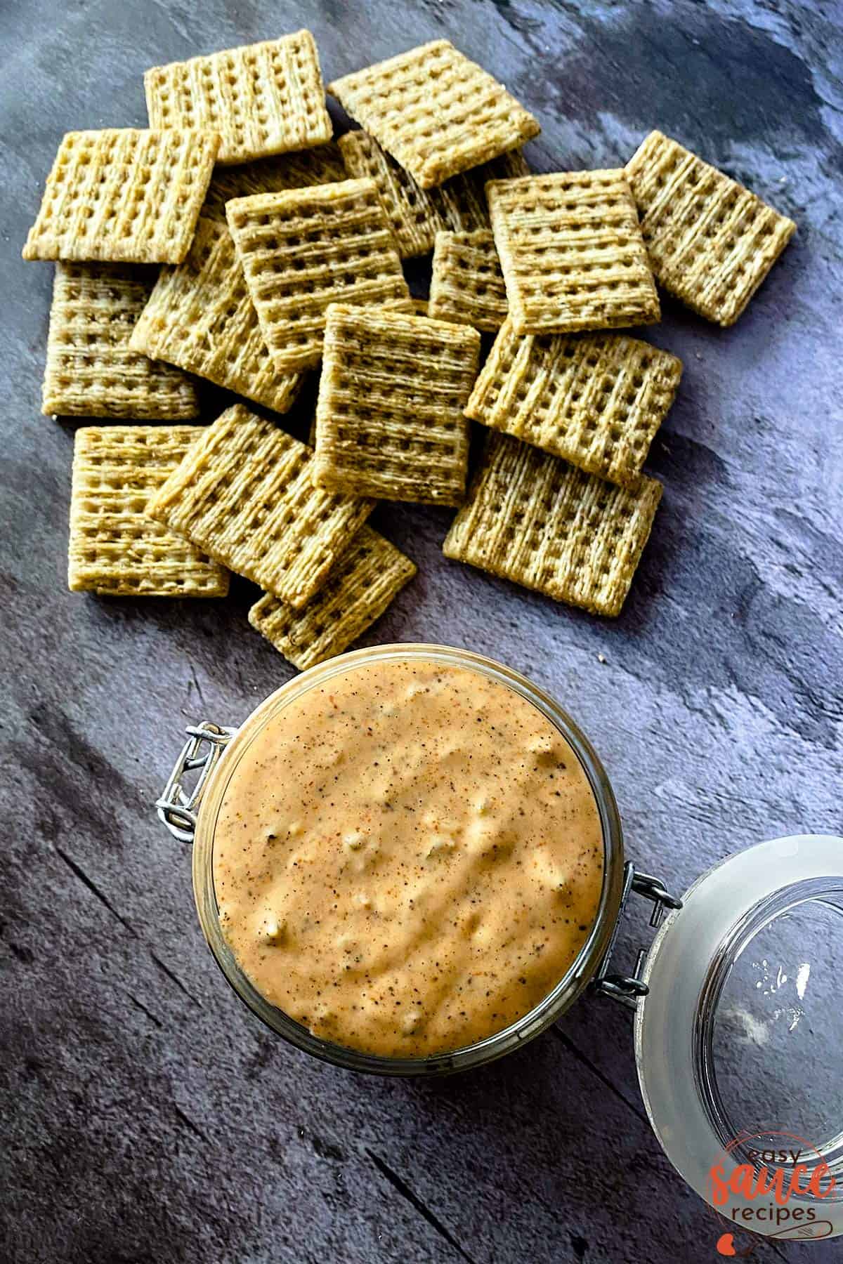 Remoulade sauce in a jar with a lid next to crackers