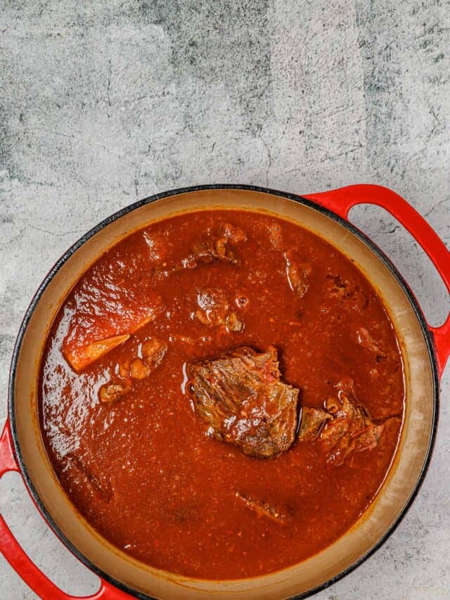 birria consome in pot with beef