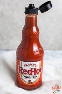 Bottled hot sauce on a white surface