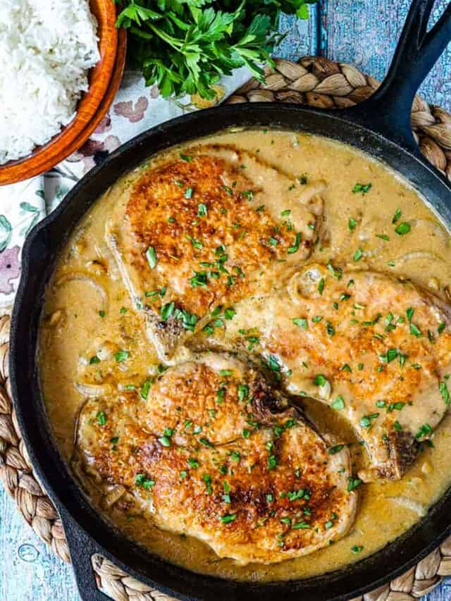 onion gravy in a skillet with pork chops