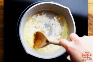Mixing flour and butter to make a roux