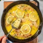 skillet with garlic lemon butter sauce and a spoon