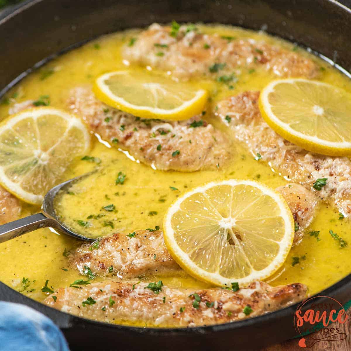 garlic lemon butter sauce in a pan with chicken tenders