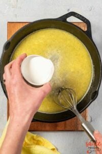 adding heavy cream to lemon garlic butter sauce