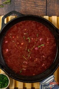 red wine added to sauce in pan