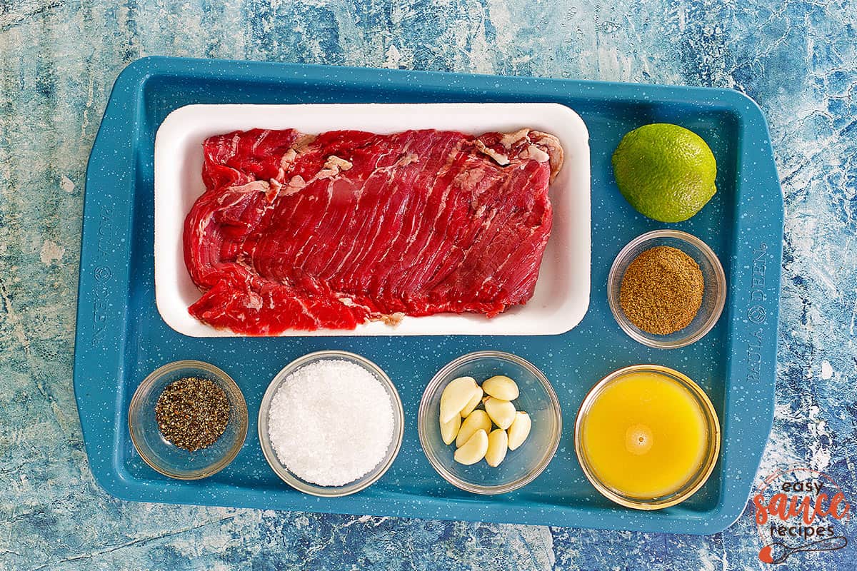 Carne asada marinade ingredients on a blue tray