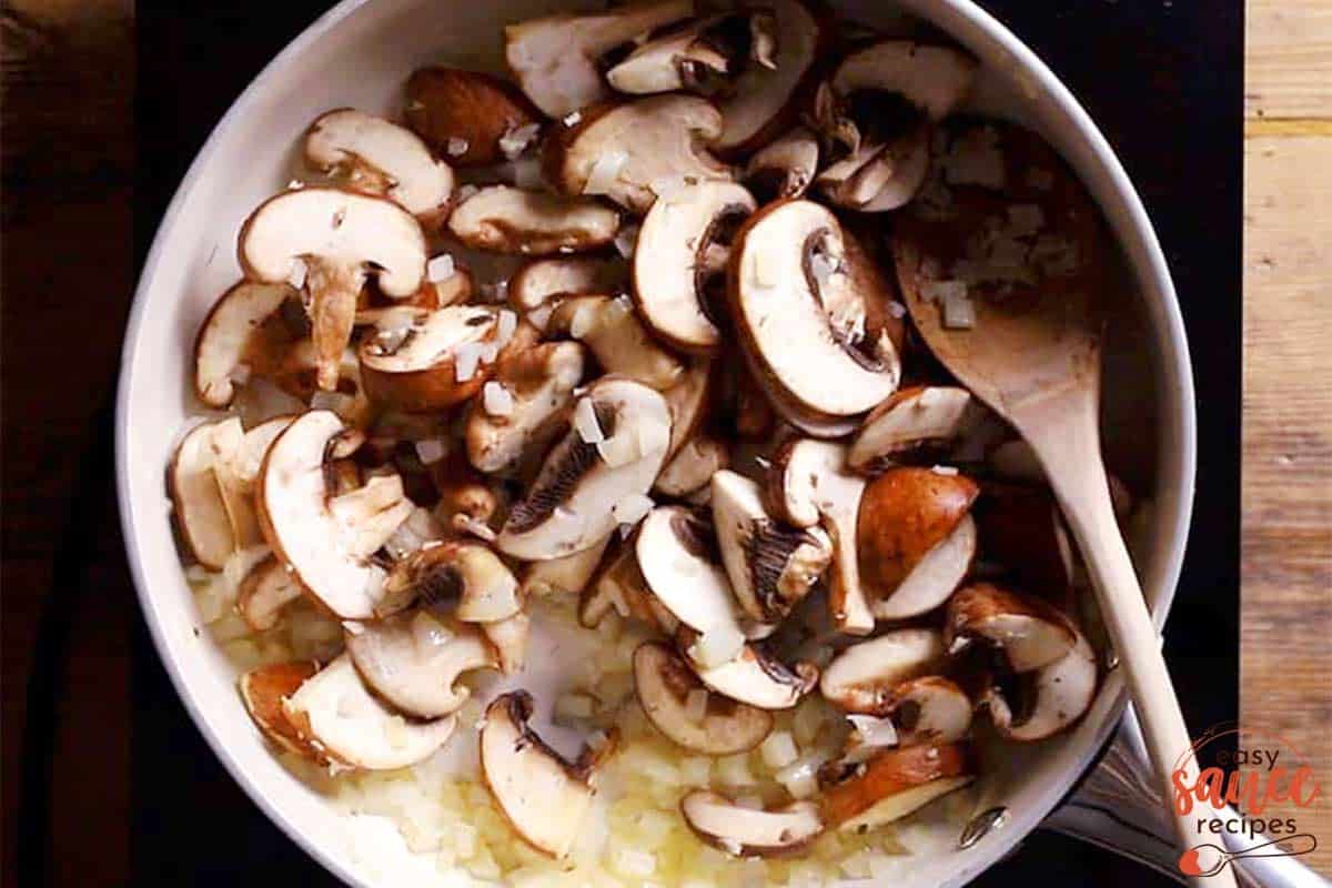 Frying mushrooms and onions in a pan