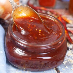 bbq sauce with a spoon in a jar
