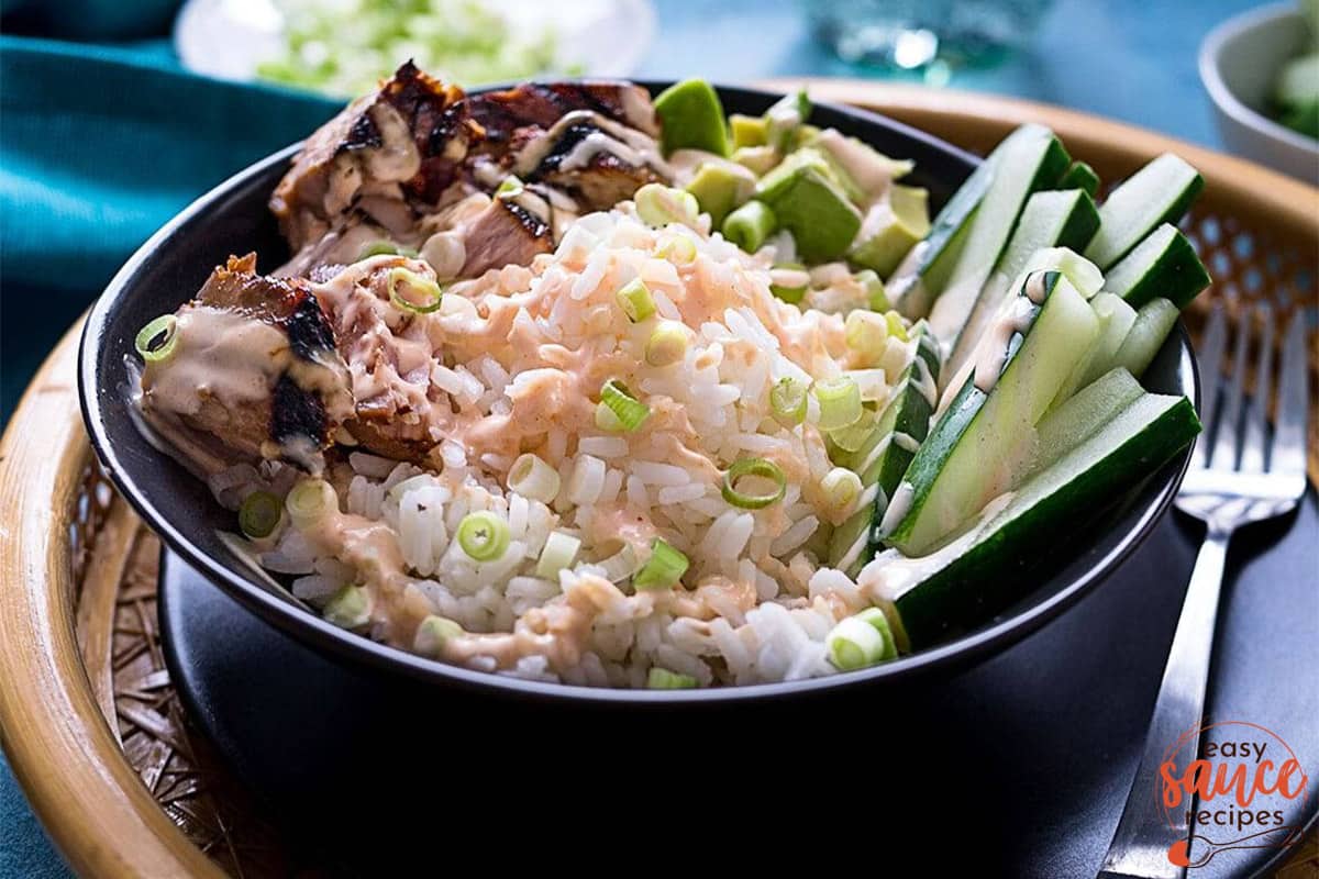 tuna and rice with yum yum sauce in a black bowl