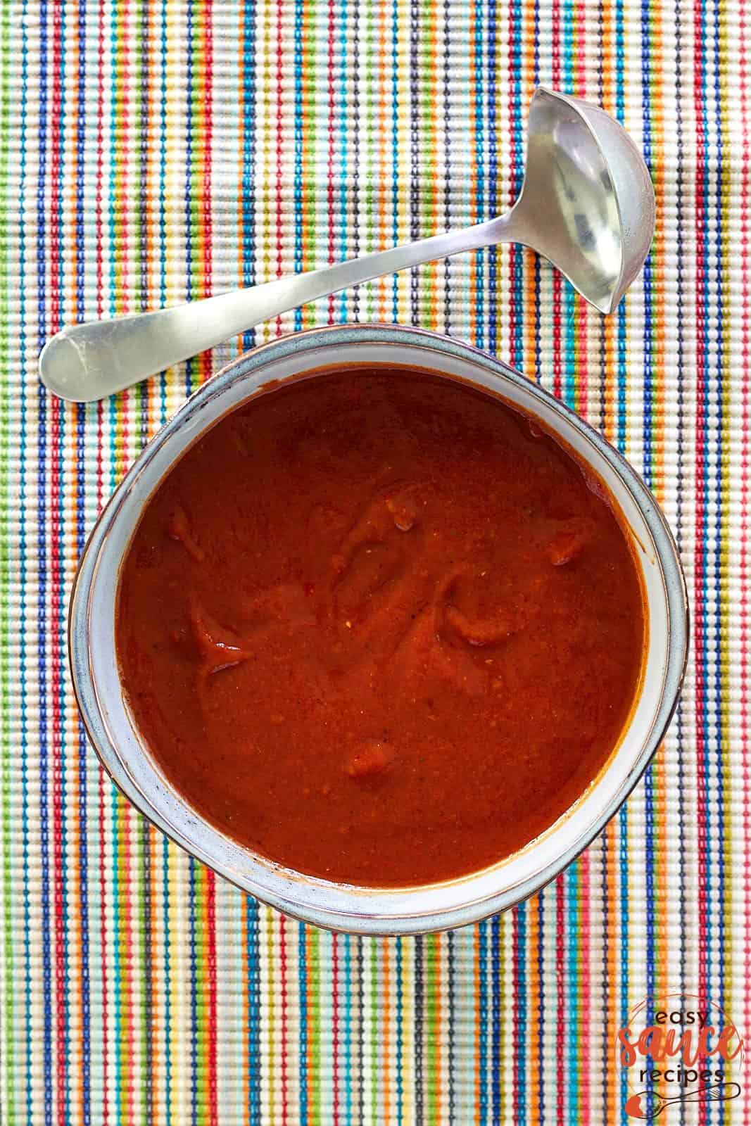 overhead shot of red enchilada sauce in a bowl