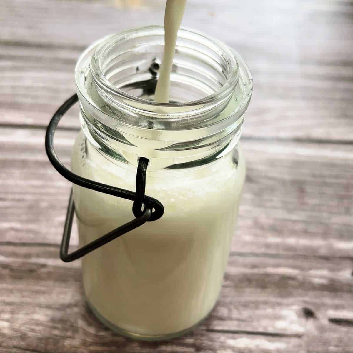 pouring buttermilk into a jar