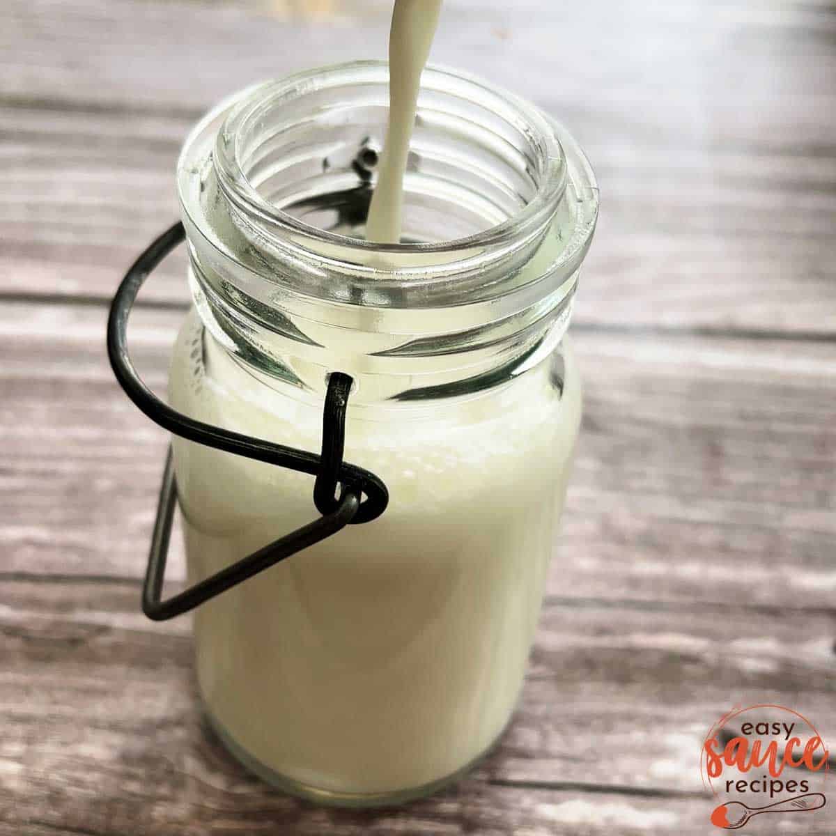 pouring buttermilk into a jar