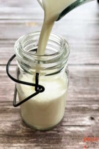 pouring buttermilk into a small jar
