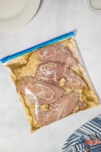 chicken marinating in buttermilk marinade in a bag
