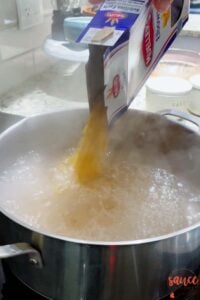 pouring pasta into boiling water